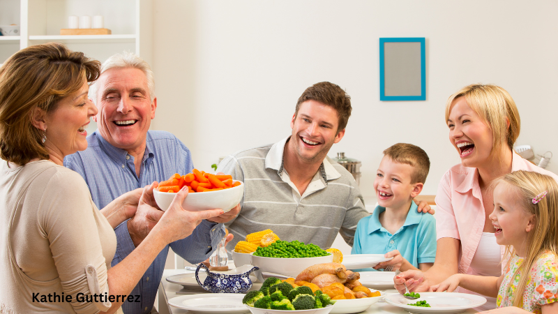 This image shows a family dining with Jesus. They are laughing and talking